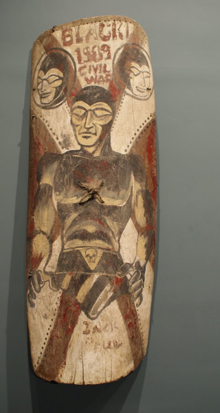 Illustration for article titled Why Does This Comic Book Hero Appear On So Many New Guinea War Shields?
